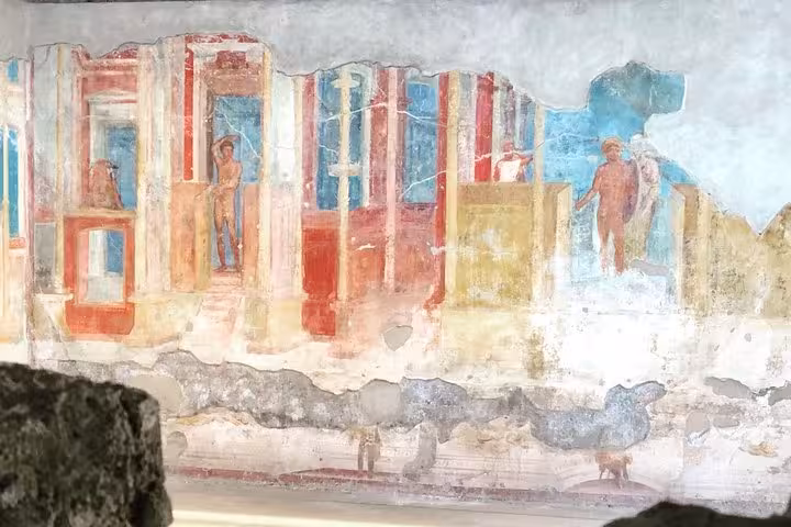 Vibrant ancient fresco in Pompeii showcasing Roman art, a highlight of the guided tour from Sorrento Coast.