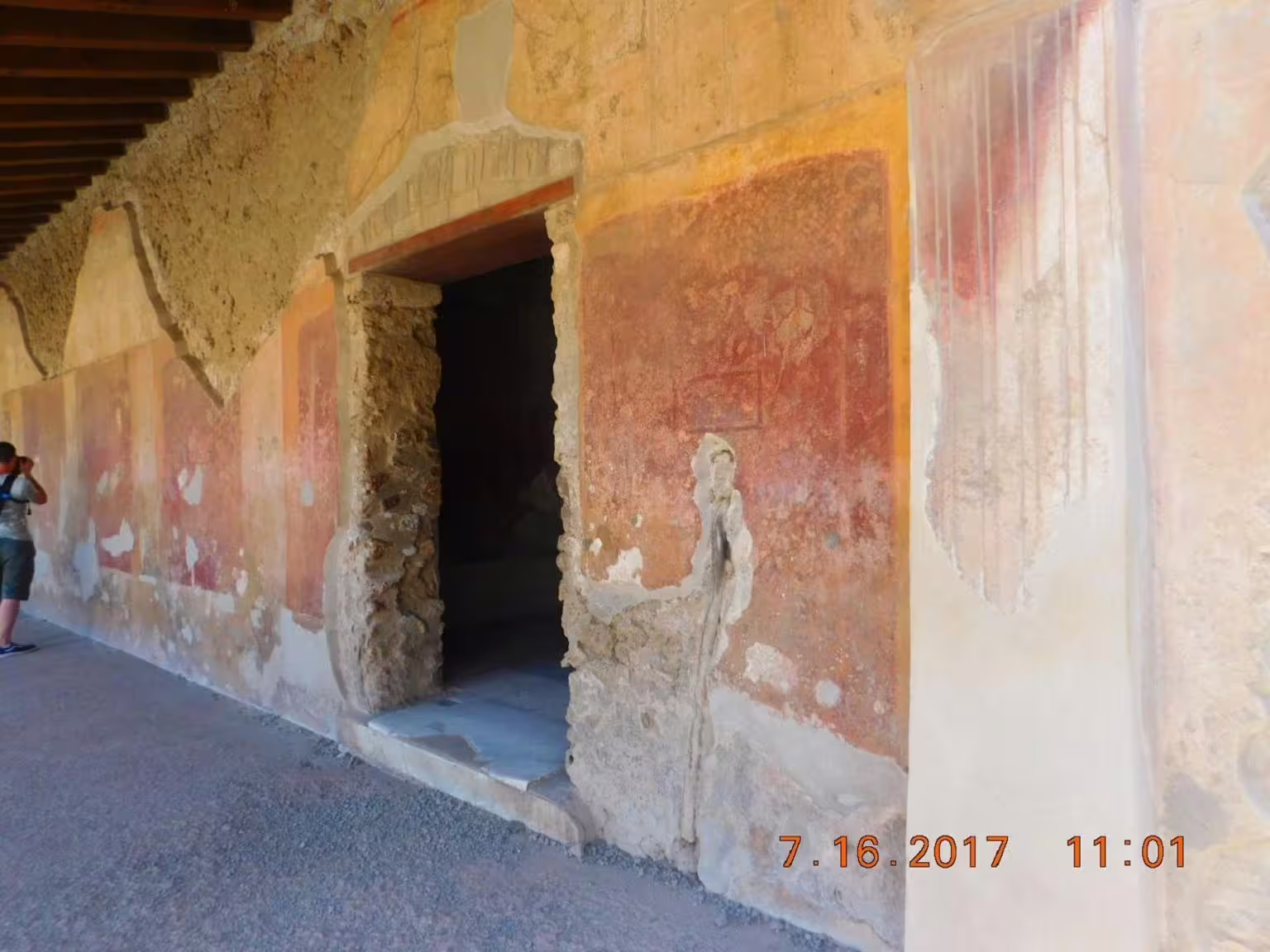 Ancient Pompeii frescoed corridor and doorway, guided stop on Pompeii & Amalfi Coast group tour from Naples