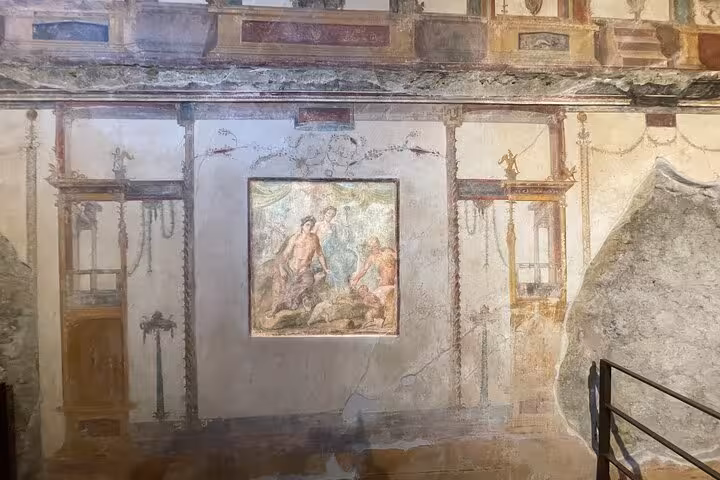 Ancient frescoes in Pompeii showcasing intricate artwork and vibrant colors, part of the Vesuvius tour from Amalfi.