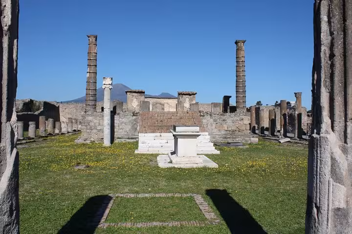 Explore ancient ruins and towering columns at Pompeii's archaeological site on a day trip from Rome.