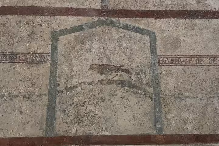 Discover detailed ancient wall art featuring a bird in Pompeii on a guided tour from Sorrento.