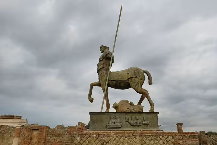 Statue of a centaur in Pompeii against a cloudy sky, a must-see on an Amalfi Coast tour.
