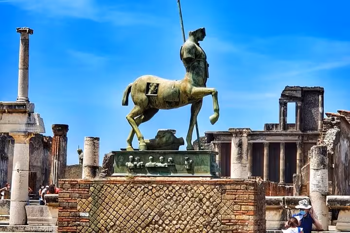Statue of a centaur amidst ancient ruins in Pompeii, highlighting the archaeological marvels of the guided tour.
