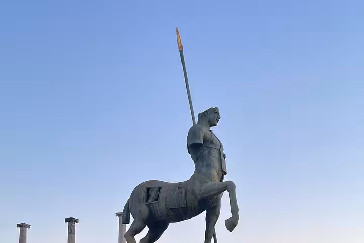 Statue of a centaur in Pompeii against a clear sky, featured in a private skip-the-line access tour.