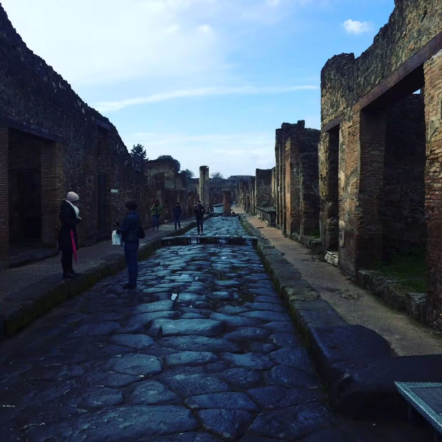 Ancient cobblestone street in Pompeii archaeological site on Naples group tour to Vesuvius