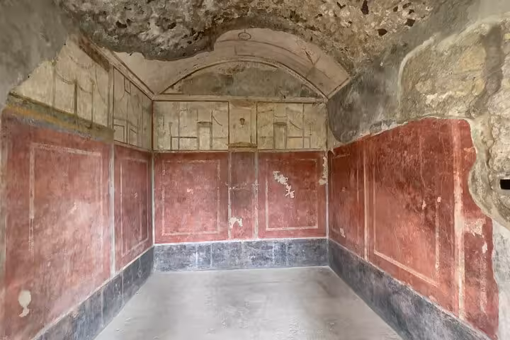 Well-preserved frescoed walls in a Pompeii room, highlighting Roman architecture on an Amalfi Coast guided tour.
