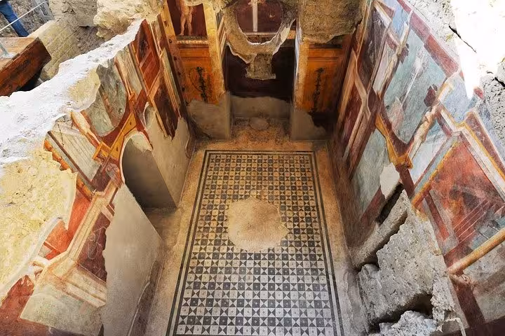 Discover intricately preserved frescoes and mosaic floors in the historic ruins of Pompeii on a private guided tour.