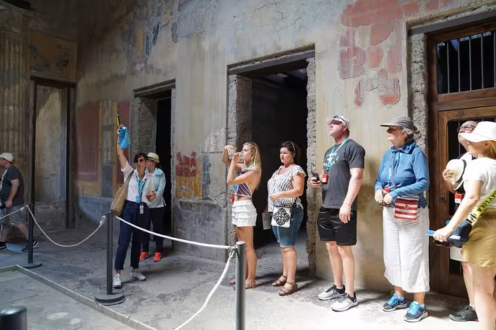 Group captures frescoes in historic Pompeii building during skip-the-line tour from Sorrento.
