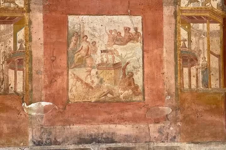 Intricate frescoes in ancient Pompeii, showcasing Roman artistry, part of the Vesuvius and wine tasting package.
