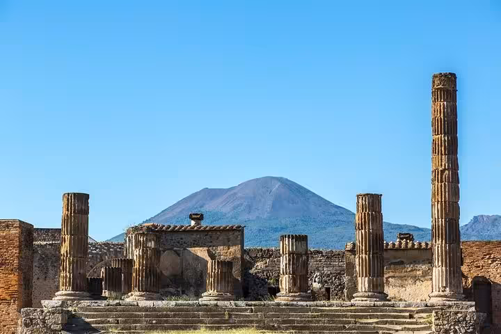 Ancient ruins of Pompeii with Mount Vesuvius in the background, showcasing the historical depth of Naples shore excursions.