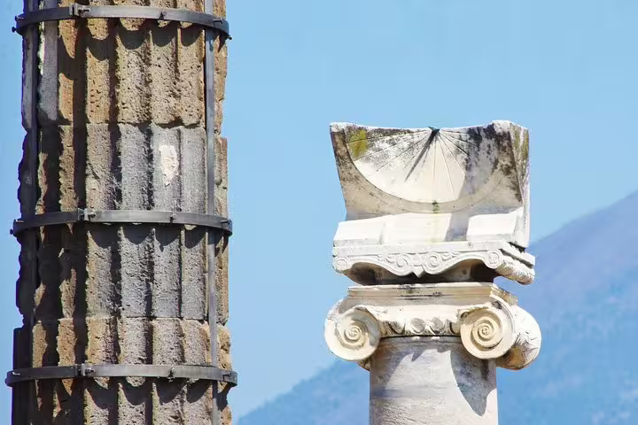 Ancient Pompeii columns and Ionic capital detail on VIP small-group guided tour from Naples
