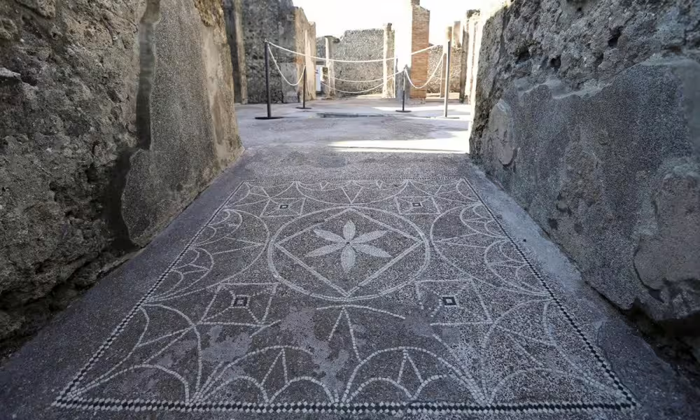 Geometric mosaic floor in a Pompeii house corridor, detail on guided walking tour of the excavations
