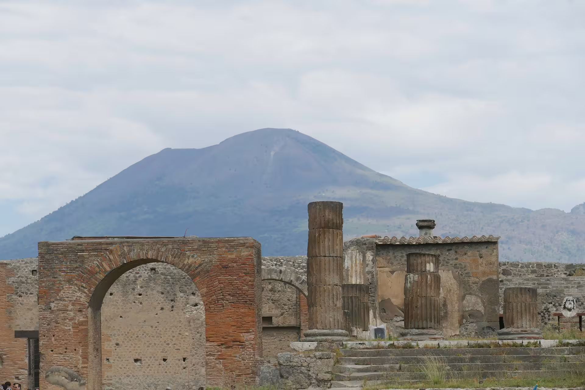 Pompeii archaeological ruins with Mount Vesuvius backdrop, low cost guided tour from Naples to Amalfi