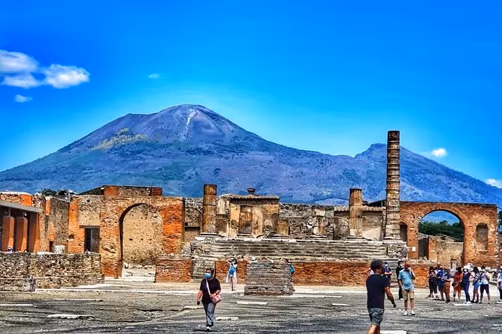 Discover the ruins of Pompeii with Mount Vesuvius looming, a highlight of our guided tour with included lunch.
