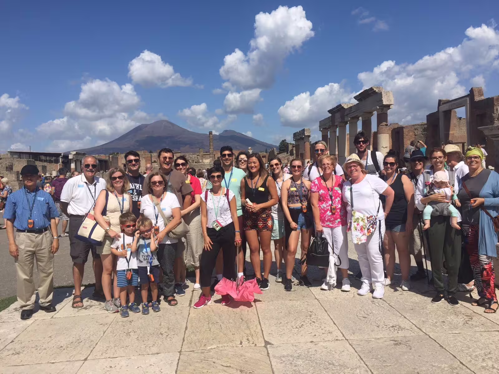 Group tour photo at Pompeii ruins with Mount Vesuvius backdrop, full-day Naples to Pompeii excursion