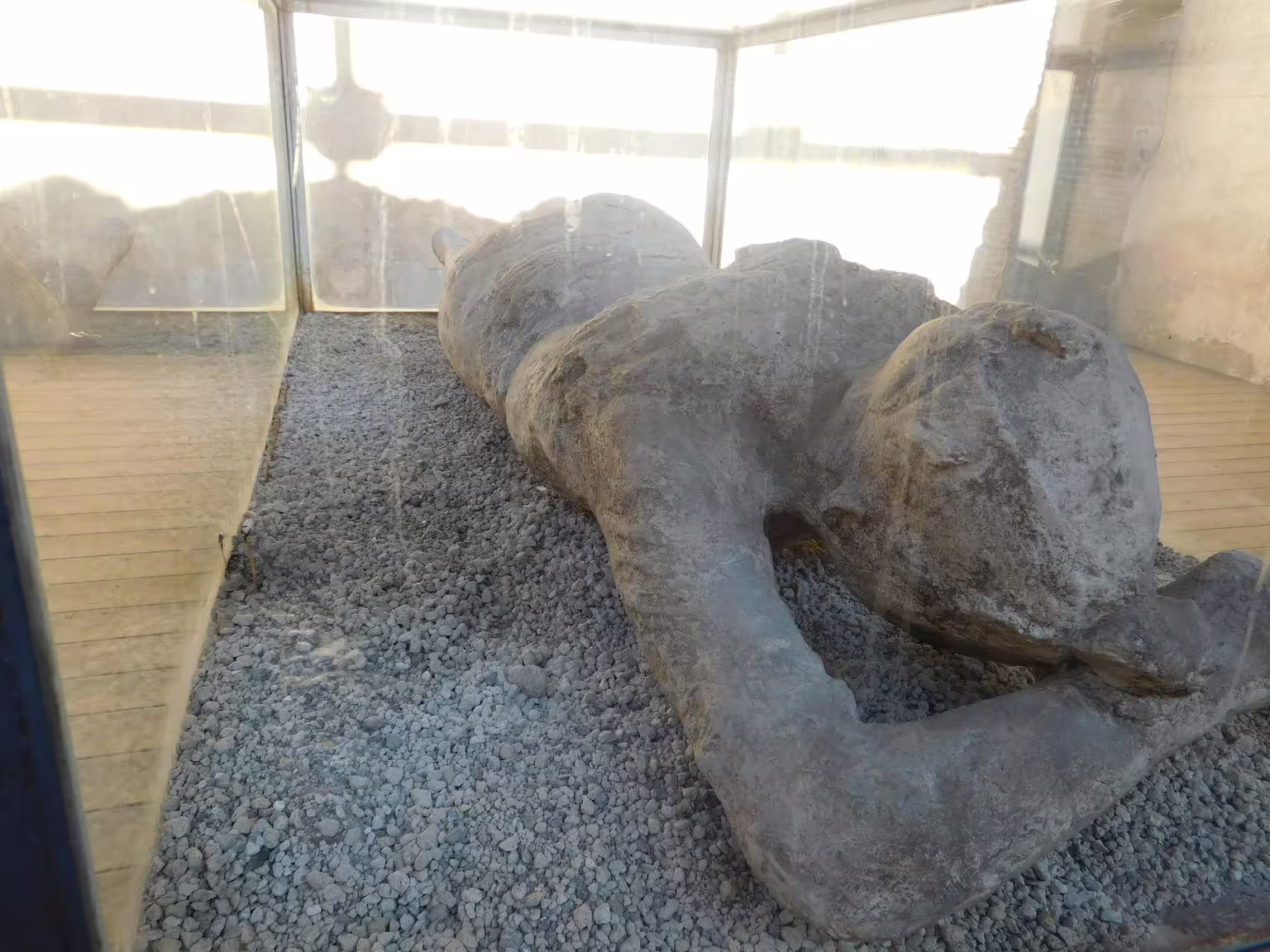 Plaster cast victim at Pompeii archaeological site, emotional highlight of Pompeii and Amalfi Coast group tour from Naples