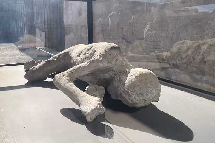 Preserved plaster cast of a victim in Pompeii, highlighting the city's tragic history.