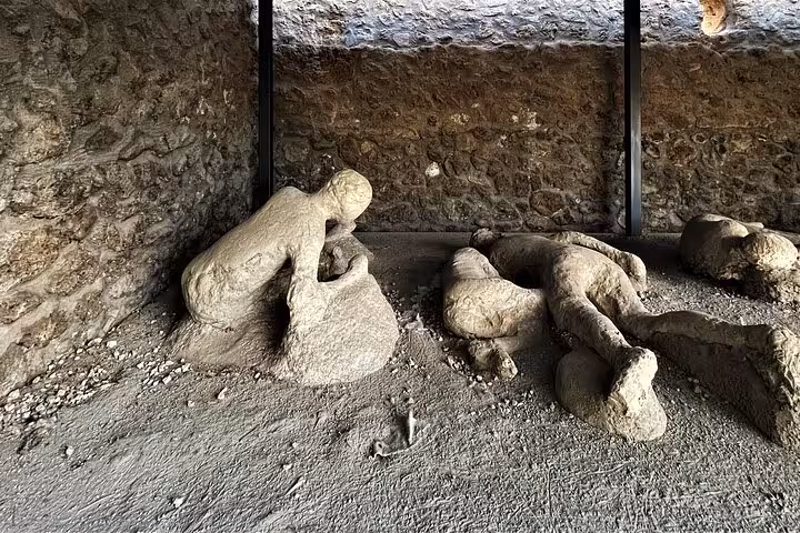Preserved plaster casts of Pompeii victims showcasing ancient history on an exclusive guided tour with skip the line access.
