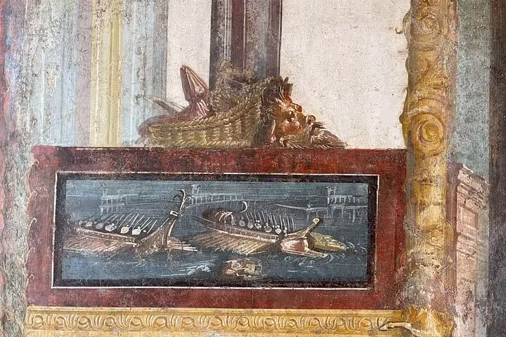 Detailed fresco depicting Roman ships and mythological scenes in Pompeii, part of a guided skip-the-line tour.