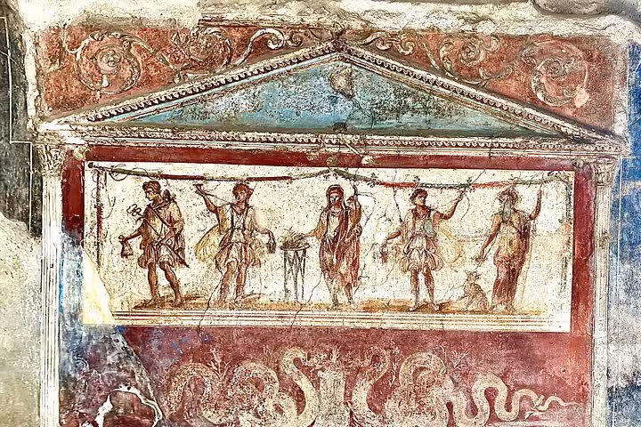 Ancient fresco depicting Roman figures in vibrant colors at Pompeii, showcased on a guided archaeological tour.