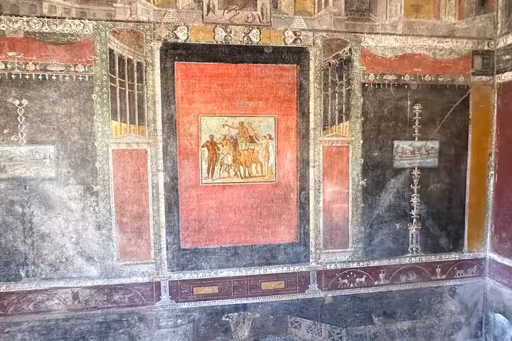 Discover vibrant frescoes in Pompeii showcasing intricate Roman art, included in the Amalfi Coast wine tasting tour.