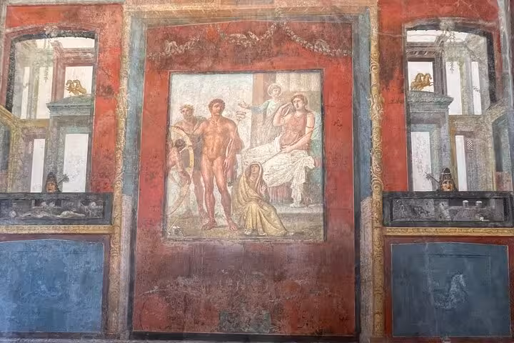 Vivid frescoes depicting Roman mythology on ancient Pompeii walls during guided tour from Positano.