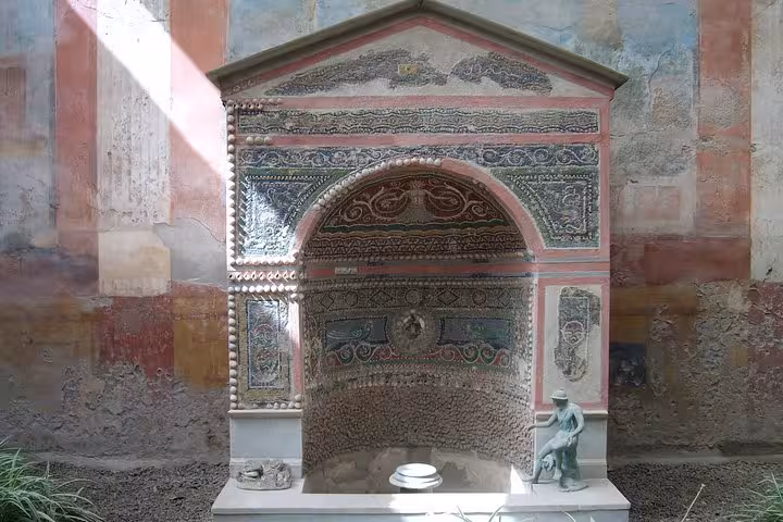 Intricate mosaic fountain in Pompeii, showcasing Roman artistry on the Pompeii & Mount Vesuvius tour.