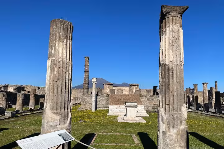 Majestic ruins and columns of Pompeii with Mount Vesuvius in the background, a highlight on the Rome transfer tour.