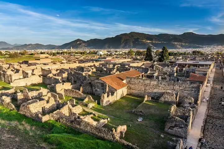 Panoramic view of Pompeii ruins with Mount Vesuvius, on a private customizable tour from Naples