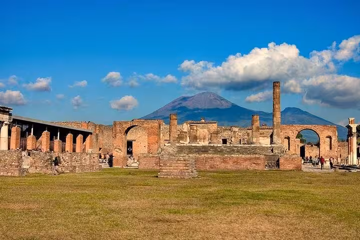 Vibrant view of Pompeii ruins with Mount Vesuvius in the background, perfect for a guided tour from Sorrento.
