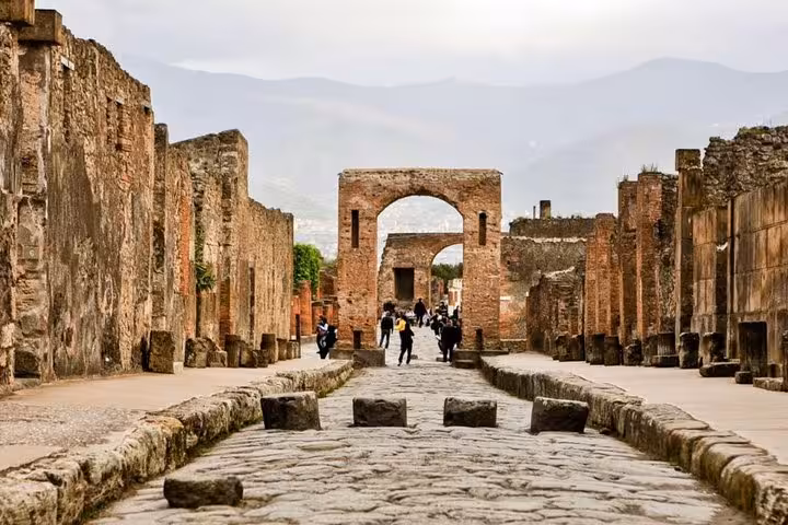 Explore ancient streets of Pompeii on a small group tour, highlighting historic ruins and stunning architecture.