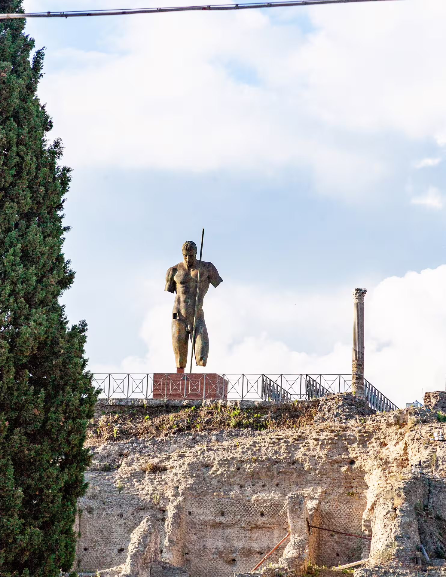 Statue among Pompeii archaeological ruins on a low cost Naples to Pompeii and Mount Vesuvius day tour