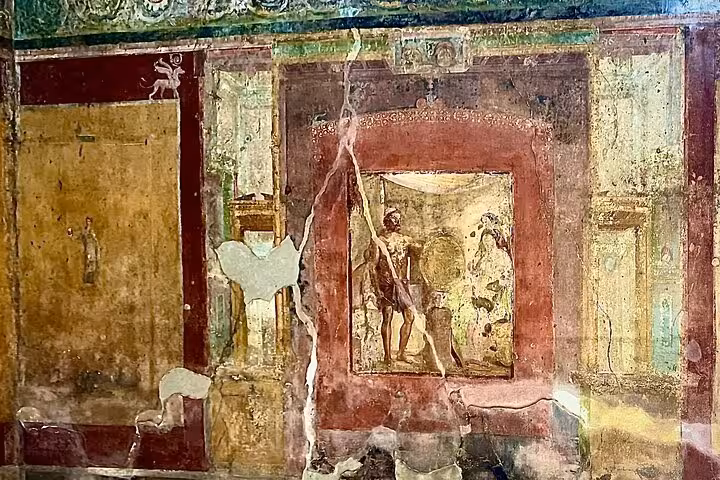Ancient fresco in Pompeii depicting mythological figures, highlighting Roman art on the Pompeii & Vesuvius tour.