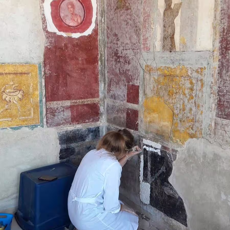 Pompeii wall fresco restoration scene on budget Pompeii and Vesuvius day trip from Naples, Italy