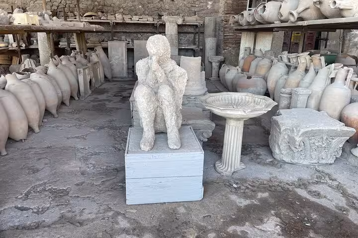 Ancient plaster cast and artifacts in Pompeii, showcasing history on the Pompeii & Vesuvius tour from Positano.
