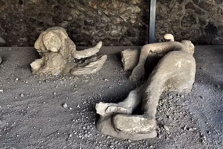 Preserved plaster casts of Pompeii victims, showcasing the tragic history of Vesuvius on an Amalfi Coast excursion.