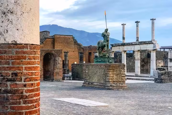 Explore ancient Pompeii ruins with Vesuvius in the background on a guided tour from Positano with lunch and wine tasting.
