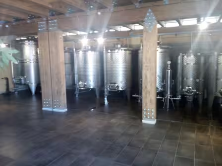 Modern stainless steel wine tanks in a Campania cellar featured on a Pompeii and Mt Vesuvius private winery tour