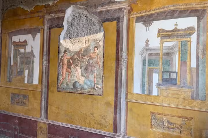 Vibrant frescoes depicting mythological scenes in a well-preserved villa at Pompeii's archaeological site.