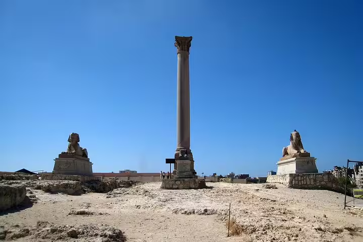 Pompey’s Pillar with sphinx statues in Alexandria, key stop on a private day tour from Cairo