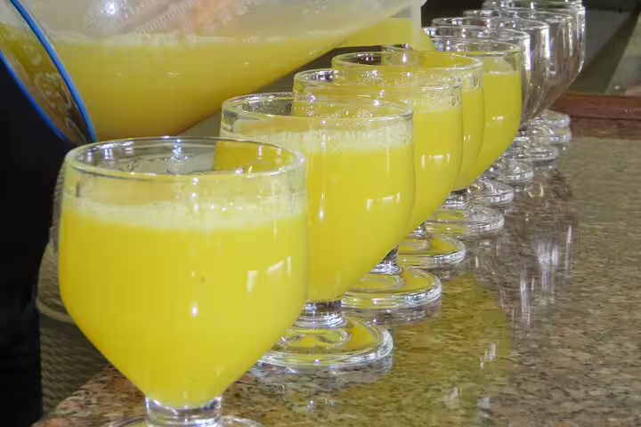 Row of fresh Poncha glasses on a granite counter, a refreshing stop during Cabo Girão 4WD mountain tour adventure.
