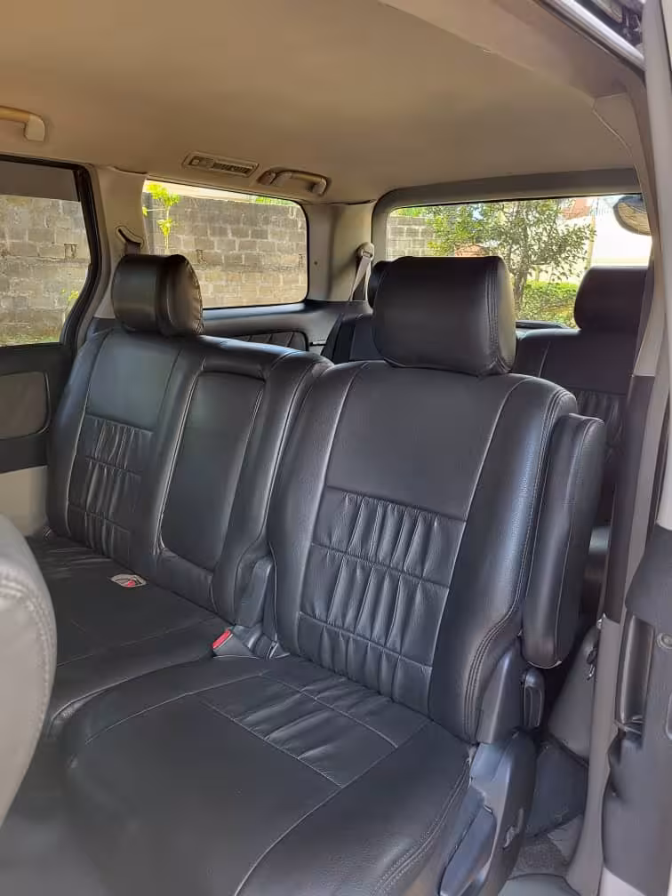 Spacious leather interior of our air‑conditioned minivan for Pongwe hotels to Zanzibar Airport private transfer