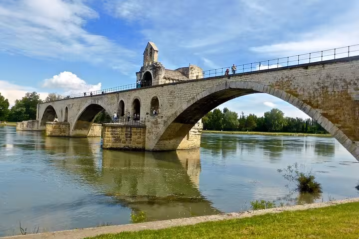 Historic Pont Saint-Bénézet bridge spanning the Rhône River under a clear blue sky in Avignon, Provence.