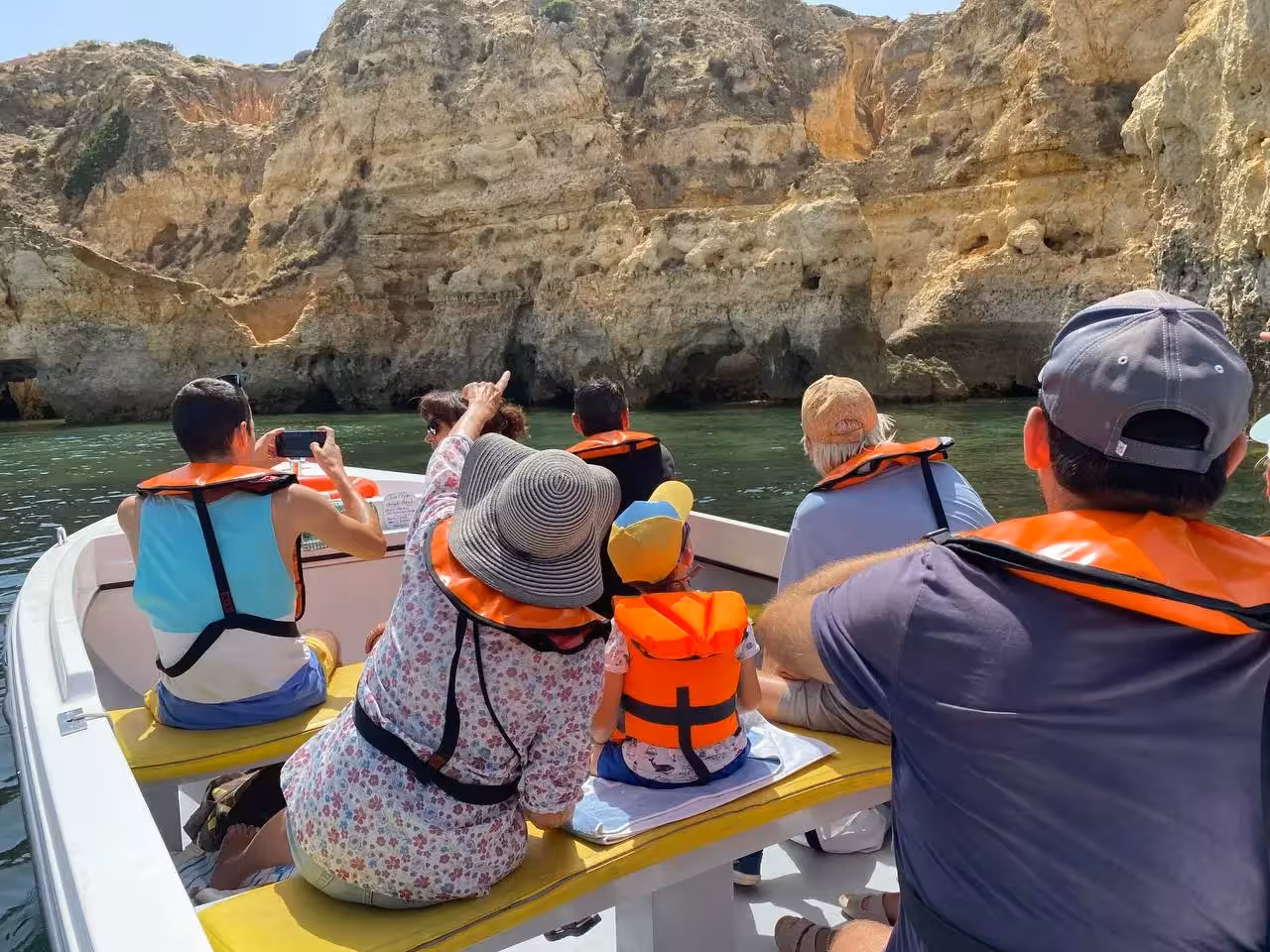 Family boat ride views rugged Algarve cliffs on the Ponta da Piedade express grotto tour near Lagos