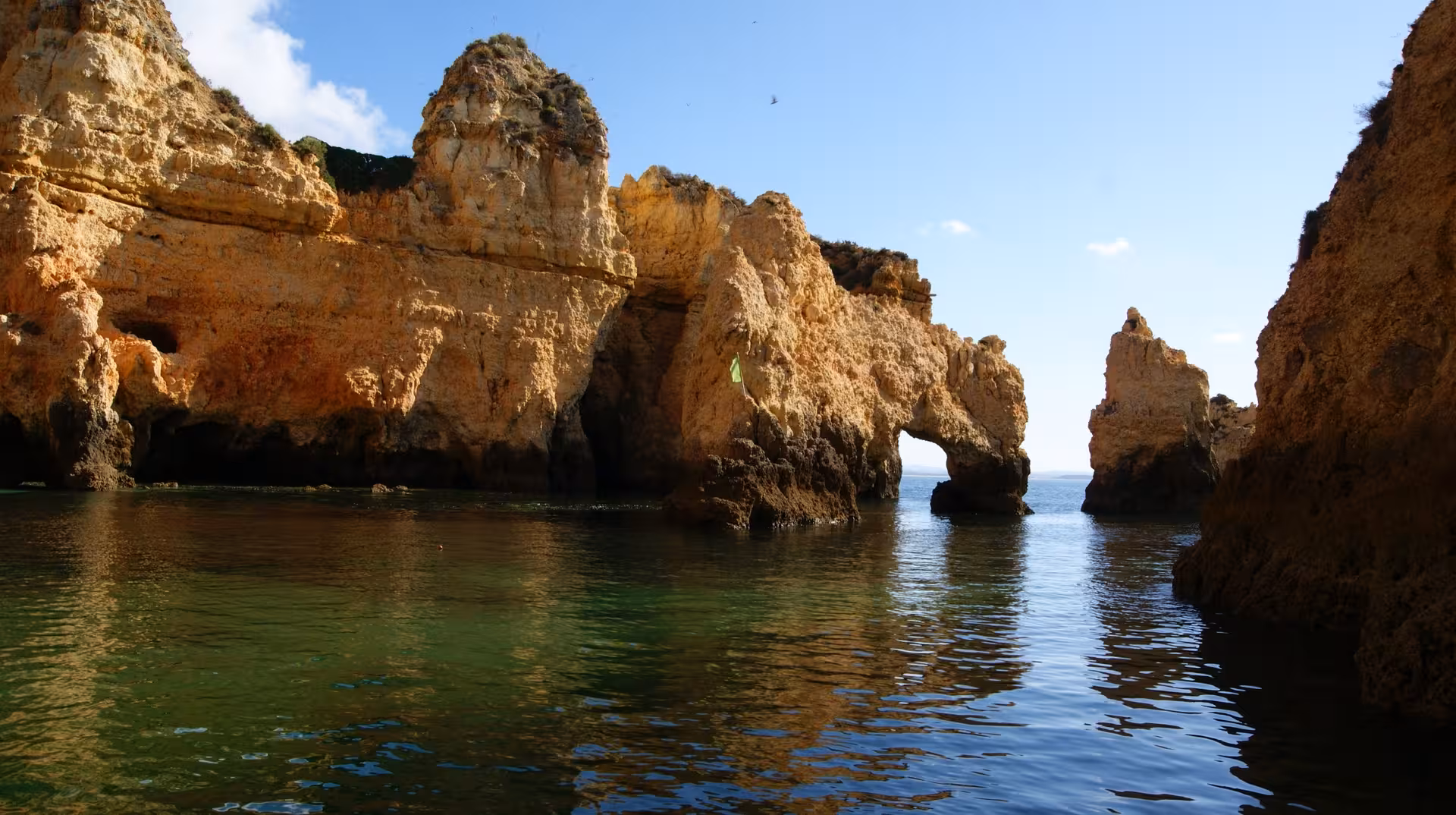 Ponta da Piedade sea arch and golden cliffs on a private boat cruise in Lagos Algarve with swim stop