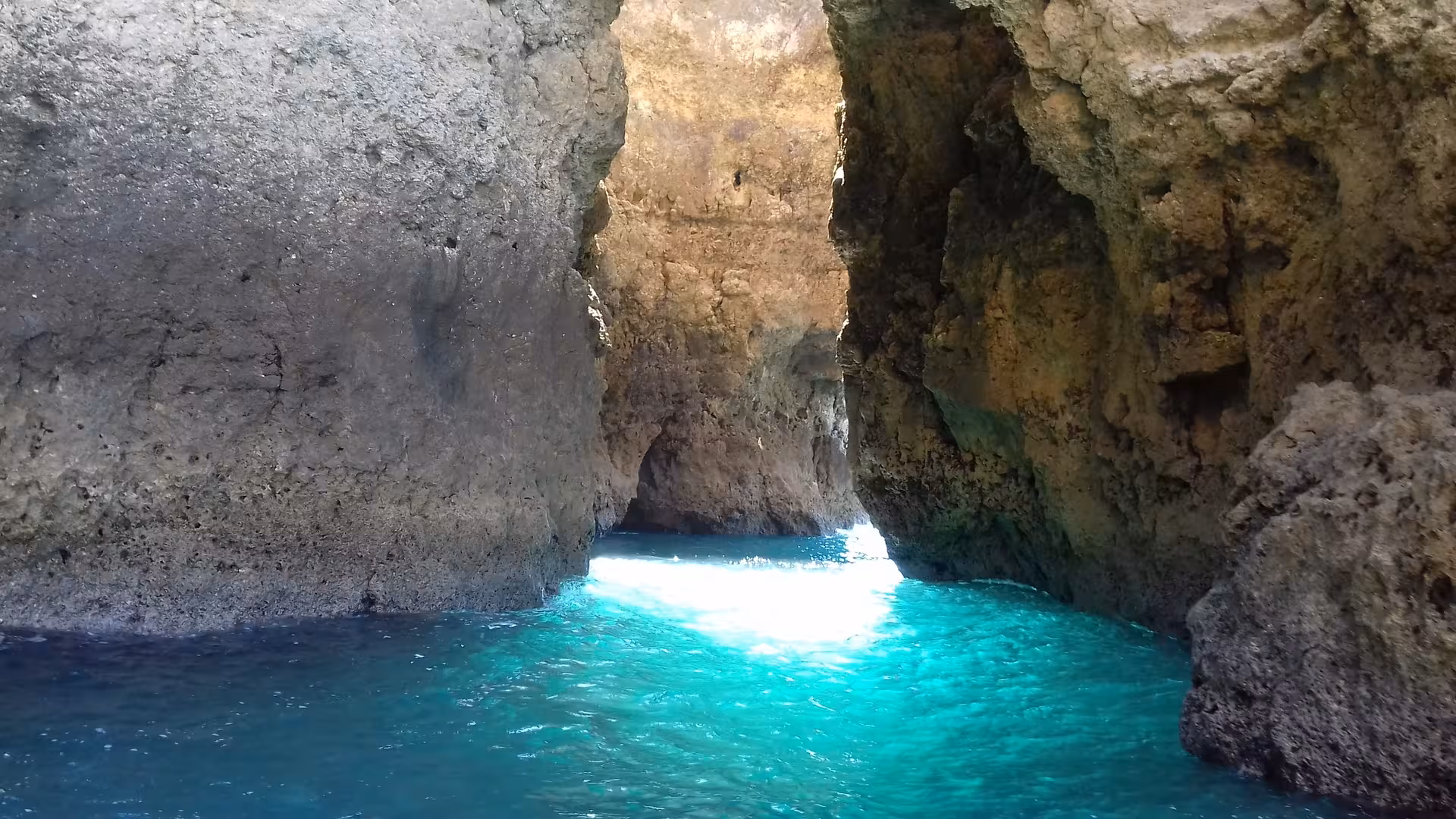 Turquoise water inside Ponta da Piedade sea cave on a private boat cruise from Lagos Algarve with swimming