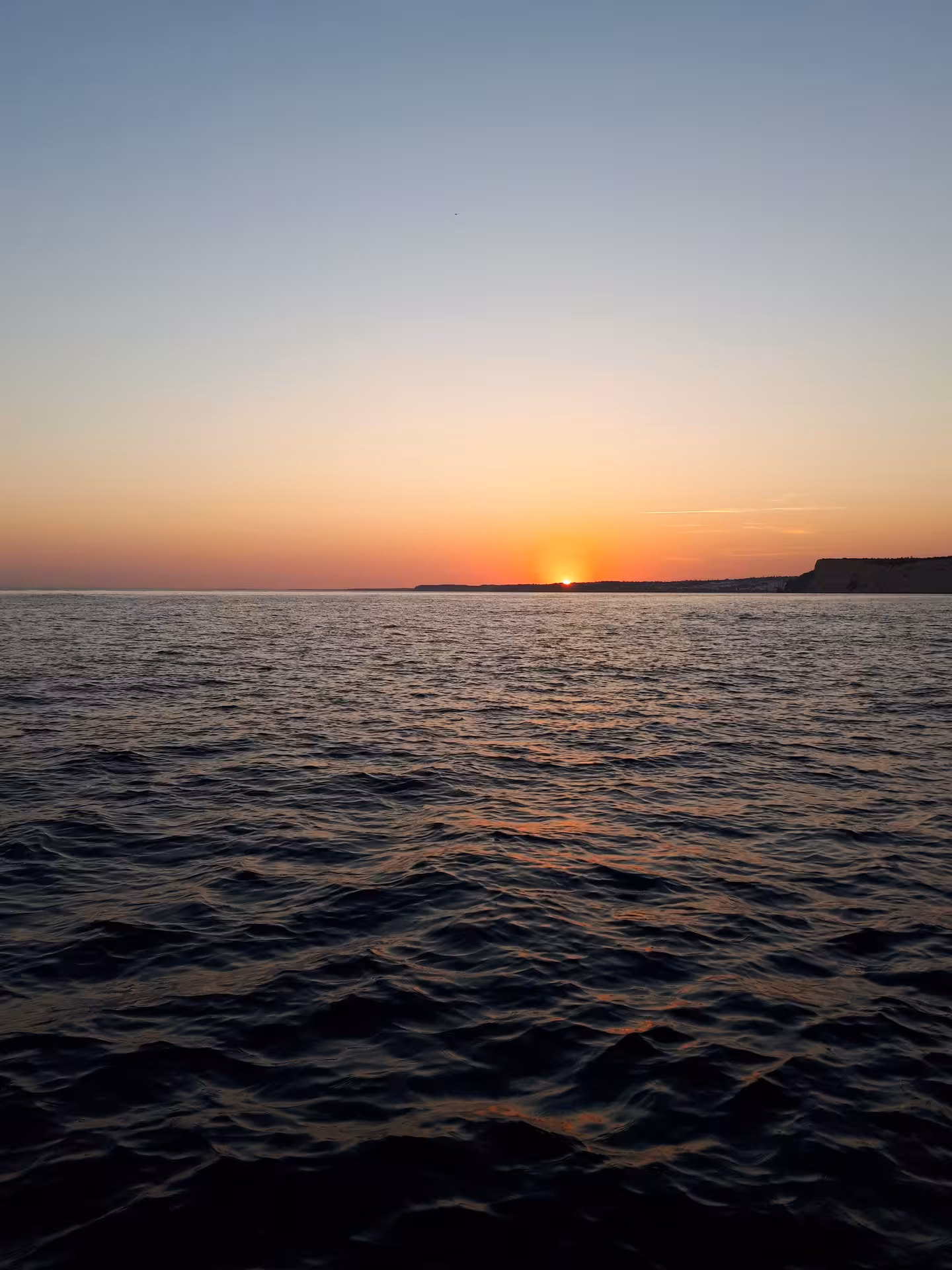 Golden sunset over the Atlantic on a private Ponta da Piedade sunset cruise departing from Lagos, Algarve