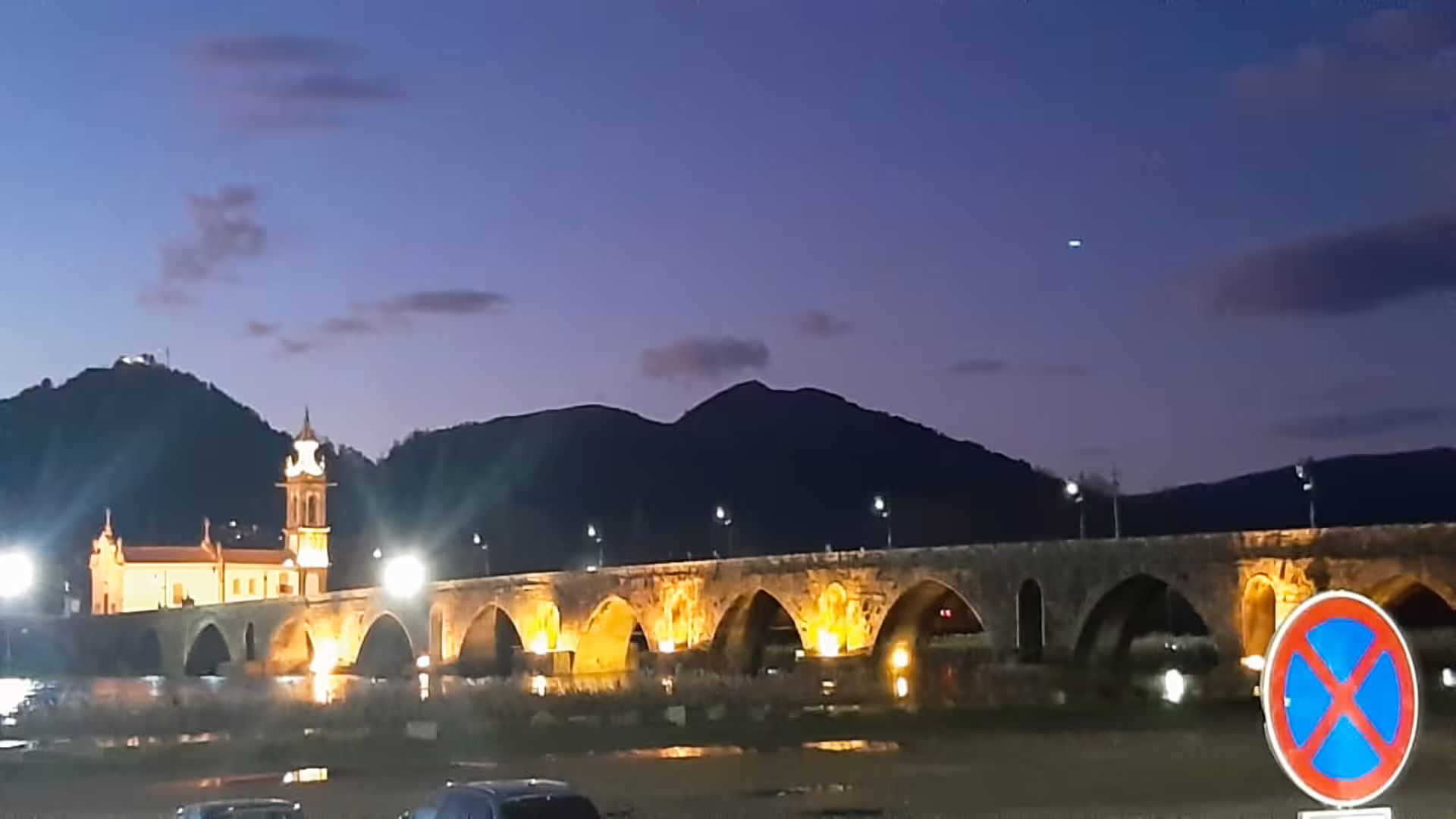Illuminated Ponte de Lima bridge at dusk, with scenic views of the Vinho Verde region, perfect for a private tour adventure.