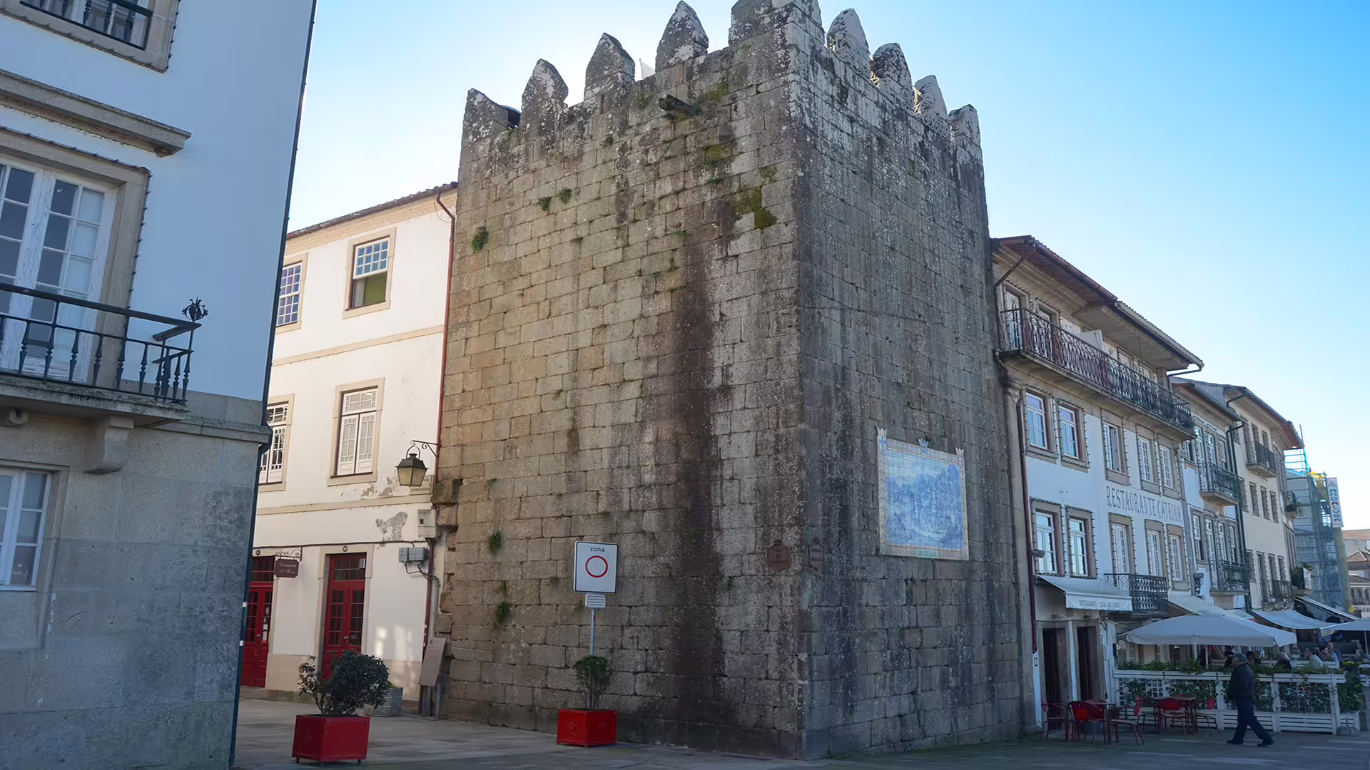 Historic stone tower in Ponte de Lima, Portugal, surrounded by charming architecture, featured on a Vinho Verde region tour.