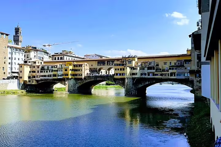 Ponte Vecchio bridge over the Arno River in Florence, seen on a guided Florence and Pisa day trip from La Spezia